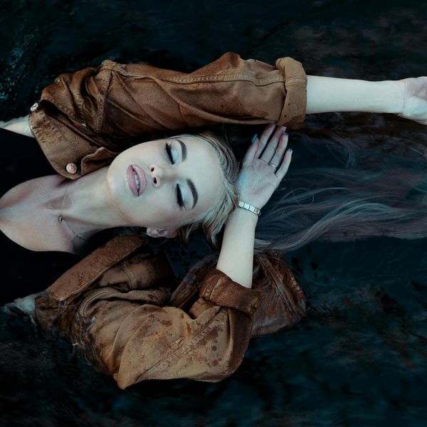 Person meditating peacefully with a backdrop of nature elements.
